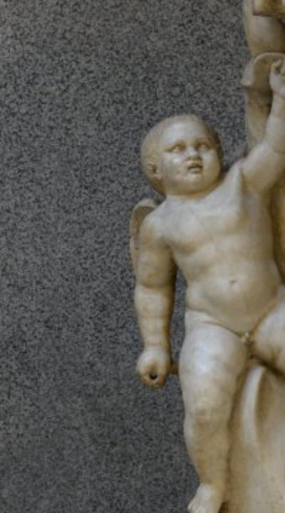 Cupid riding a dolphin at Augustus's feet